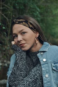 Portrait of beautiful young woman in forest