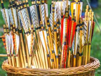 Close-up of arrows in wicker basket