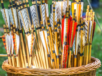 Close-up of arrows in wicker basket