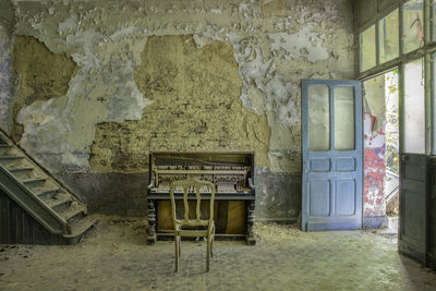 Empty chair in abandoned building