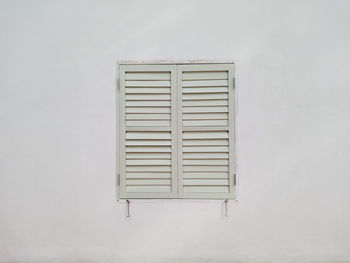 Close-up of closed window on white wall