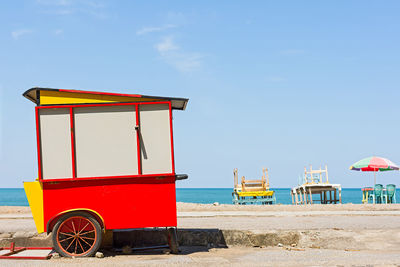 Lifeguard hut on beach against sky