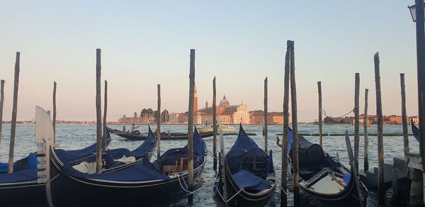 Boats in sea against clear sky