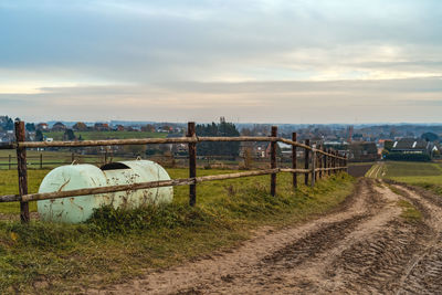 Road amidst field against sky