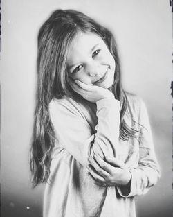 Portrait of smiling young woman standing against blurred background