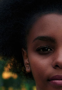 Close-up portrait of young woman with curly hair