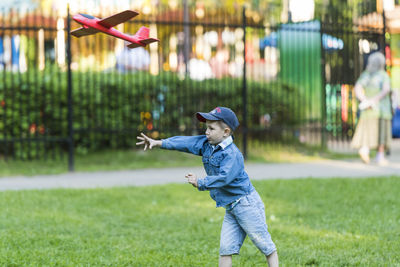 Full length of boy playing on grass