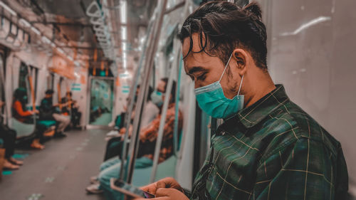 Portrait of young man using mobile phone