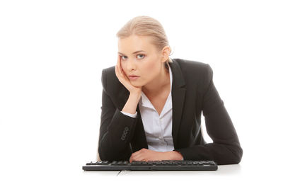 Portrait of young woman using smart phone against white background