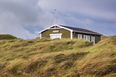 House on field against sky