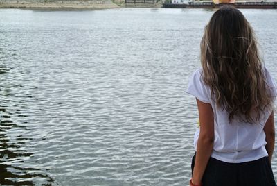 Rear view of woman standing in sea