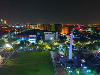 High angle view of illuminated buildings in city at night