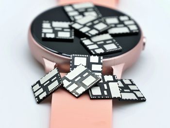 High angle view of clock on table against white background