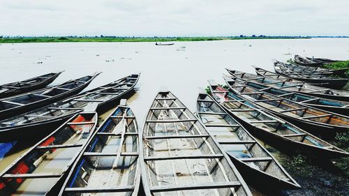 High angle view of boats moored at shore against sky