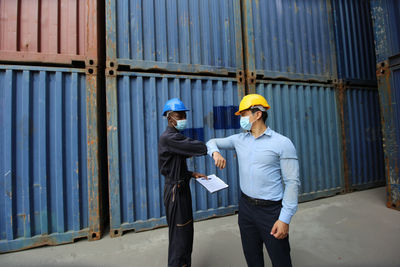 Full length of a man standing against wall