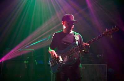 Man playing guitar at music concert