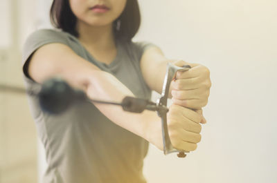 Midsection of woman standing against white background