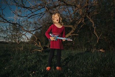 Full length of a girl playing on field