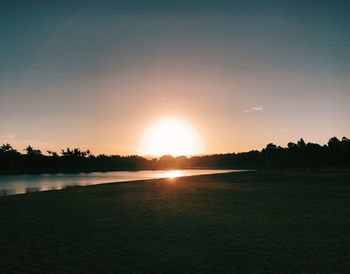 Scenic view of beach against sky during sunset