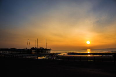 Scenic view of beach against sky during sunset