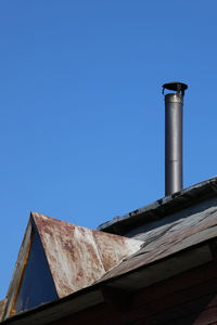 Low angle view of smoke stack against sky