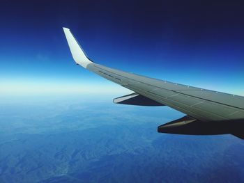 Cropped image of airplane flying over clouds