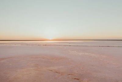 Scenic view of sea against clear sky during sunset