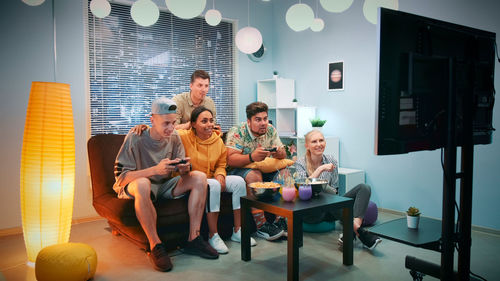 Portrait of smiling family sitting at home