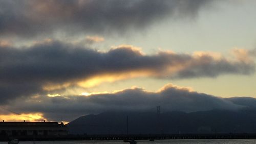 Scenic view of mountains against cloudy sky