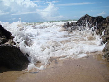 Waves splashing on rocks at beach