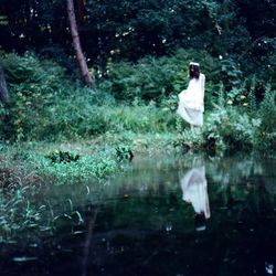 Woman standing in pond