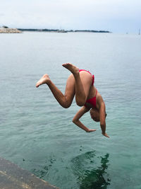 Girl jumping in the sea