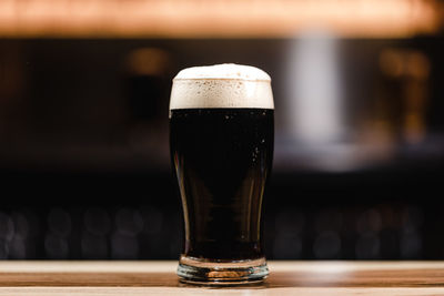 Close-up of beer glass on table