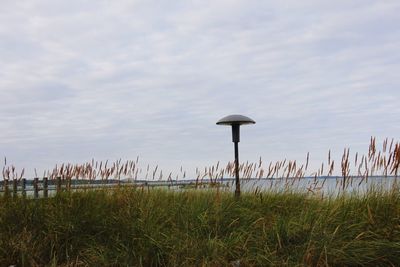 Scenic view of field against cloudy sky