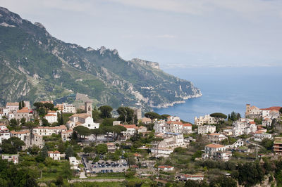 High angle view of townscape by sea against sky