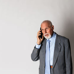 Mid adult man standing against white background