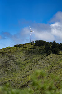 Low angle view of windmill against sky