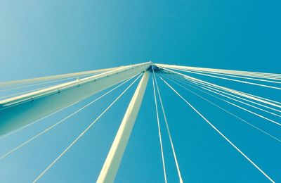 Low angle view of bridge against clear blue sky