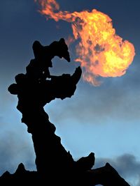 Low angle view of silhouette statue against sky during sunset