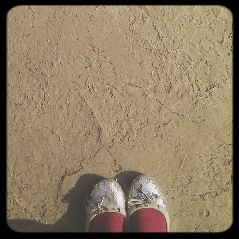 low section, person, shoe, personal perspective, sand, human foot, beach, standing, high angle view, auto post production filter, transfer print, footwear, lifestyles, footprint, leisure activity, unrecognizable person, outdoors