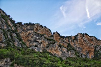 Low angle view of rock formation against sky