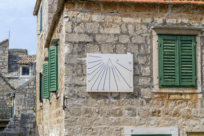 Low angle view of window on wall of building