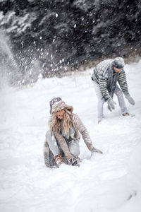 People in snow on field