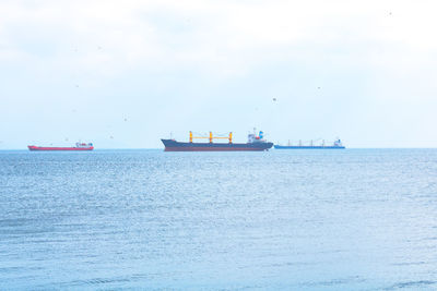 Ship sailing on sea against sky