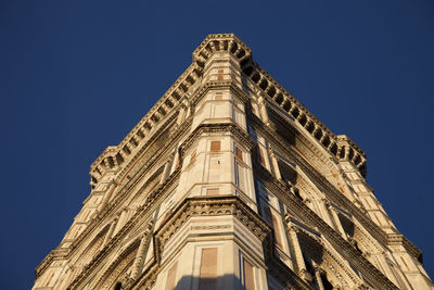 Low angle view of building against blue sky