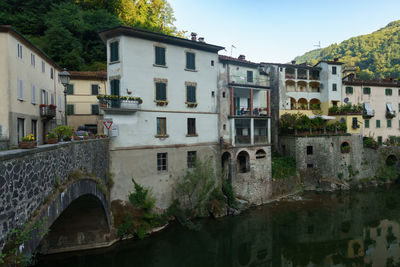 Arch bridge over river against sky