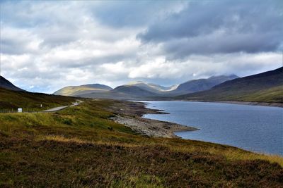 Scenic view of lake and mountains against sky