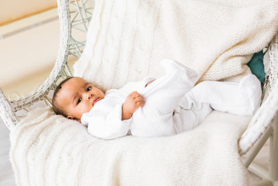 Cute baby lying on bed