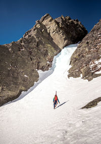 Person skiing on snowcapped mountain