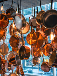 Low angle view of cooking utensil for sale at market stall